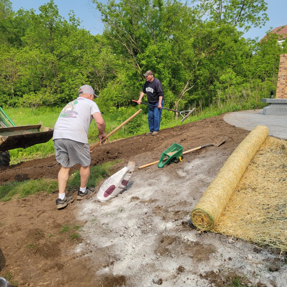 Landscapers working on adding grass