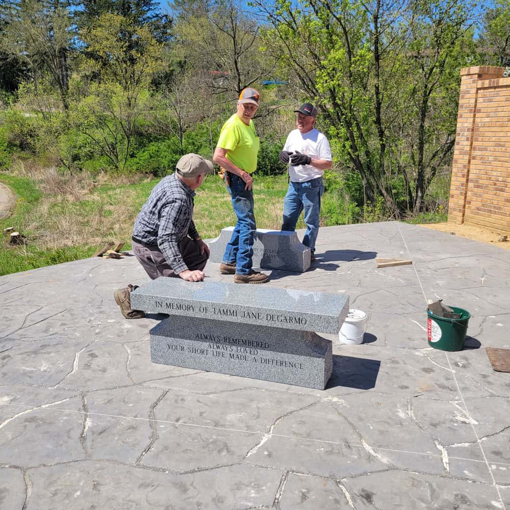 Workers placing the granite benches